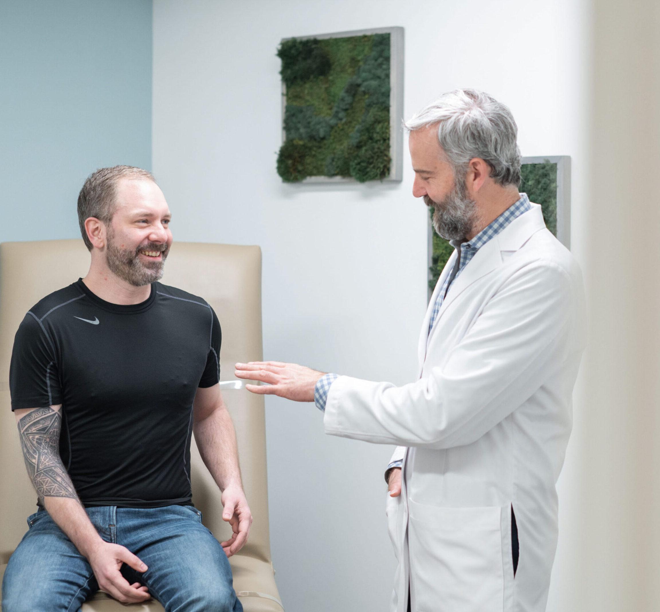 Dr. Donaldson discussing male breast reduction surgery options with a patient